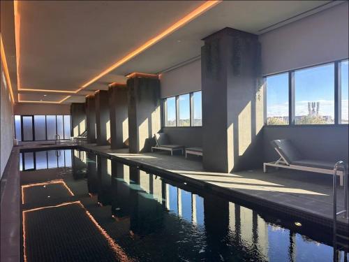 a large swimming pool in a building with a pool at Sky One Harmony in Box Hill