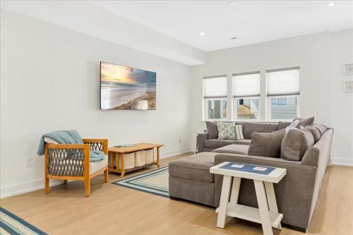 a living room with a couch and a table at Spacious Newly Built Townhouse 2 blocks to Beach in Ventnor City