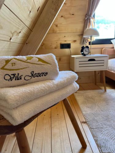 a room with a bed and a chair with a desk at Vila Jezero-Jajce in Jezero