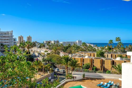 a view of a city with palm trees and buildings at GOLDEN VIEW Ponderosa in Costa de Adeje