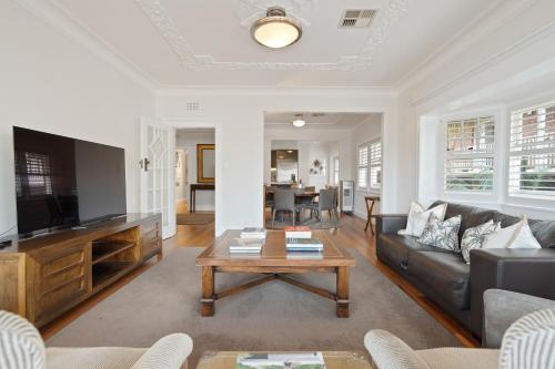 a living room with a couch and a coffee table at The Bay Retreat - Neutral Bay in Sydney