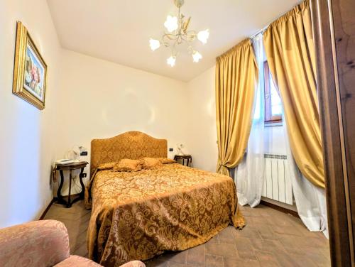 a bedroom with a bed and a window at Residence Villa La Fornacina in Incisa in Valdarno
