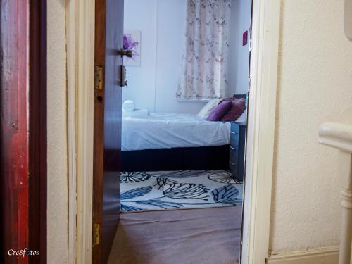 a room with a bed and a room with a doorway at WoodHus Lodge Fantastic Large Double Room 3 in Stoke on Trent
