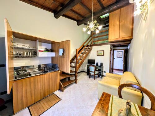 a kitchen and living room with a couch and a table at Residence Villa La Fornacina in Incisa in Valdarno