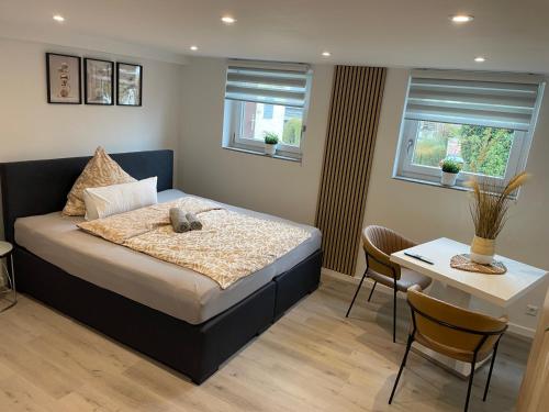 a bedroom with a bed with a teddy bear on it at Ferienwohnung in Kuppenheim für 1 bis 2 Personen in Kuppenheim