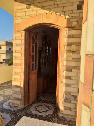a building with a door in a brick wall at One Love Guesthouse & Restaurant in Luxor