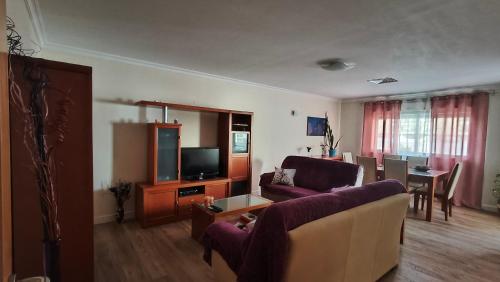 a living room with a couch and a tv at Rooms_Heart Apartment in Faro