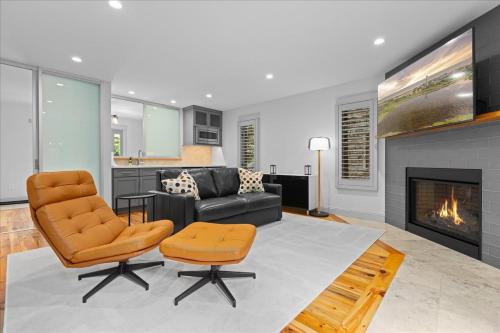 a living room with a couch and a chair and a fireplace at Luxurious 3BR Retreat in Serene Cape May Point in Cape May