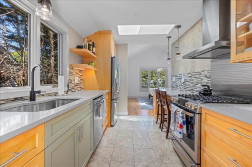 a kitchen with a sink and a stove top oven at Luxurious 3BR Retreat in Serene Cape May Point in Cape May