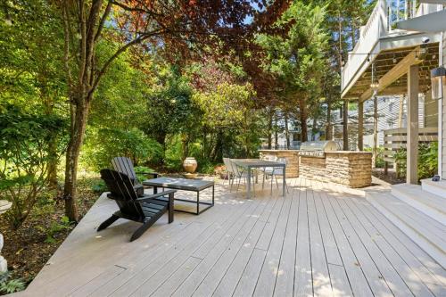 a wooden deck with two chairs and a table at Luxurious 3BR Retreat in Serene Cape May Point in Cape May