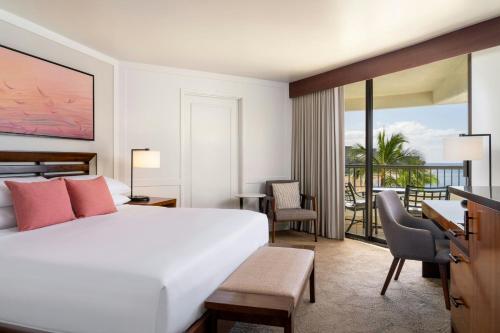 a bedroom with a large white bed and a balcony at Sheraton Maui Resort & Spa in Lahaina