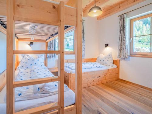 a bunk bed room with two bunk beds in a cabin at Peilberg in Hollersbach im Pinzgau