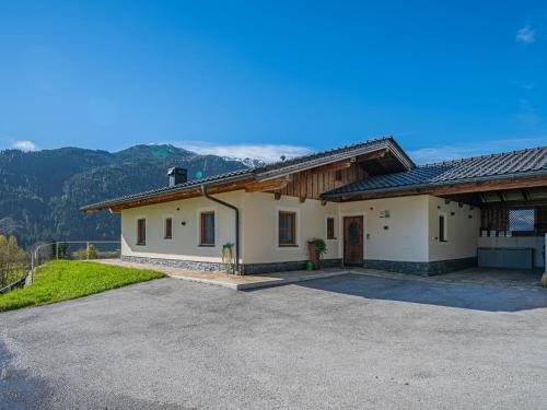 a large white house with mountains in the background at Peilberg in Hollersbach im Pinzgau