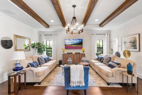 a living room with couches and a chandelier at Elegant 4BR Home Guest House Private Yard in West Palm Beach