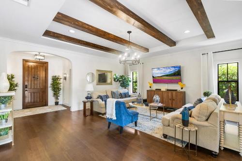 a living room with white walls and wooden ceilings at Elegant 4BR Home Guest House Private Yard in West Palm Beach