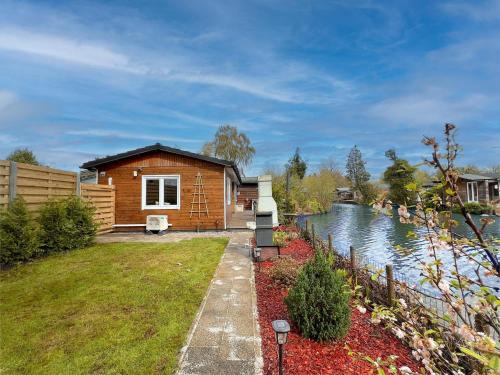 a log cabin next to a river at Fonnies Chalet in Laakdal