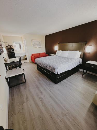 a hotel room with a bed and a desk at Travel Inn New Castle Airport in New Castle