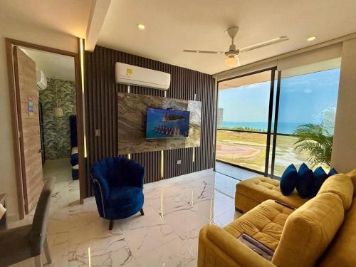 a living room with two couches and a view of the ocean at Lujoso apto con vista al mar, en salinas del mar in Playa Dormida