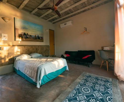 a bedroom with a bed and a couch at Habitación, balcón frente al mar y alberca in Lerma