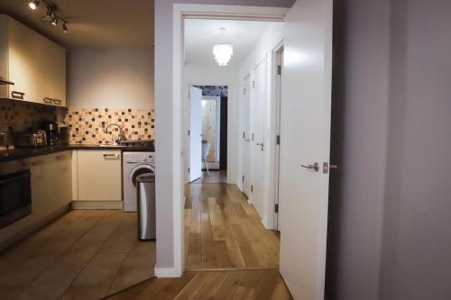 a kitchen with a door open to a hallway at Great location, direct links to London Bridge! in Forest Hill