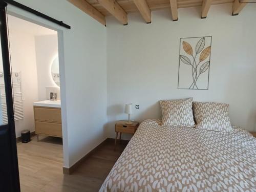 a bedroom with a bed and a sink at Gîte calme avec wifi et piscine partagée en pleine nature - FR-1-410-466 in Conlie