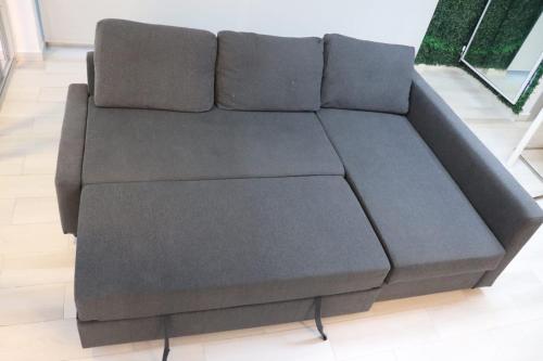 a brown couch sitting in a living room at Romana Golf Suite in El Soco