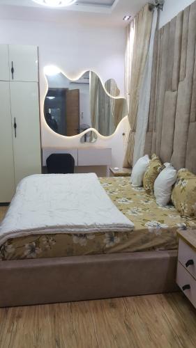 a bedroom with a large bed with a large mirror at The Haven in Ikota