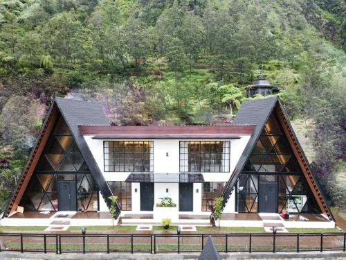 an image of a house with a mountain in the background at The Sikarim Waterfall View Villa in Kejajar