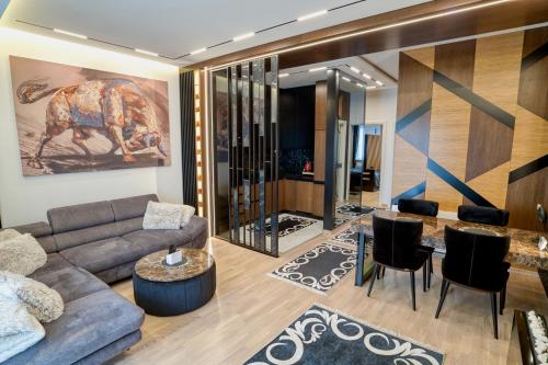 a living room with a couch and a table and chairs at Luxury Suite Veselić in Valjevo