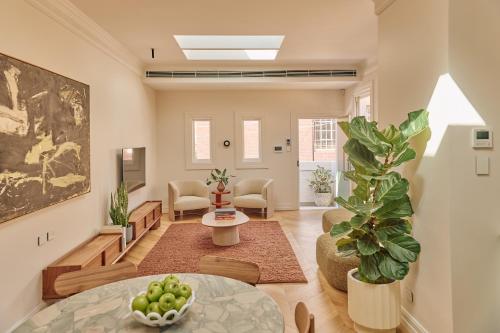 a living room with a table and a plant at Mucca Suite in Sydney