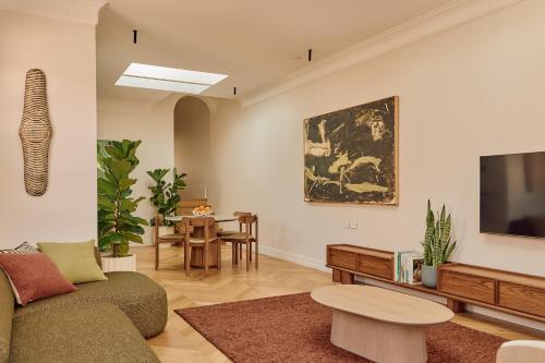 a living room with a couch and a tv at Mucca Suite in Sydney