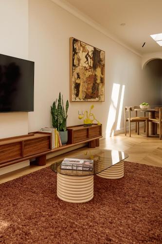 a living room with a tv and a coffee table at Flora Suite in Sydney