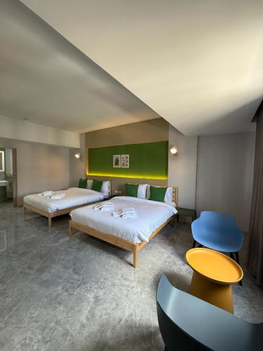 two beds in a room with two tables and two beds sidx sidx sidx at Chill Chill Hotel in Krabi