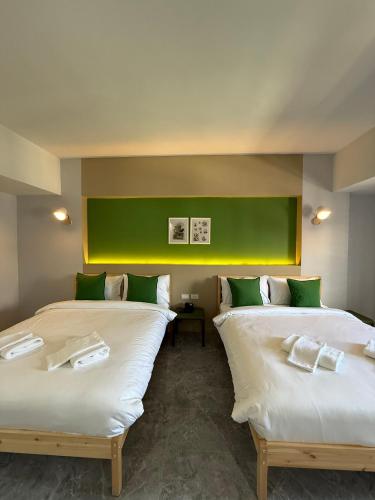 two beds sitting next to each other in a room at Chill Chill Hotel in Krabi
