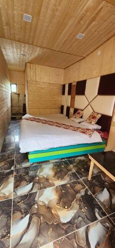 a bedroom with a bed with a painting on the floor at Hotel Big Dreams in Kolur