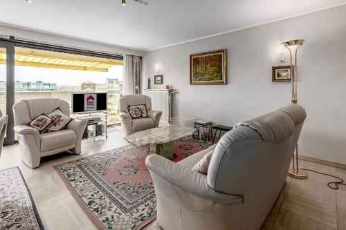 a living room with two chairs and a table at Stephanie 0406 G30 in Sint-Idesbald