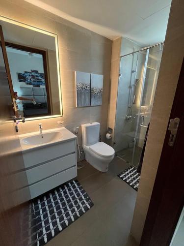 a bathroom with a toilet and a sink and a shower at Colombo, Trizen Luxury Apartments, Sri Lanka in Colombo