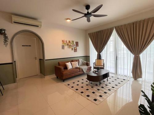 a living room with a couch and a ceiling fan at Teega Residence B L2 near Legoland by UCoMeStay in Iskandar Puteri