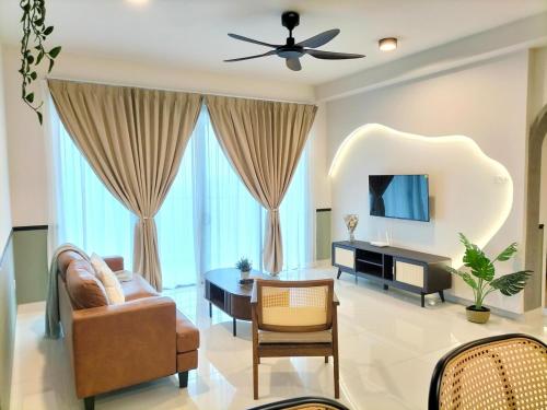 a living room with a ceiling fan and a couch at Teega Residence B L2 near Legoland by UCoMeStay in Iskandar Puteri