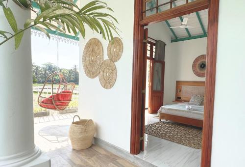 a room with a door leading to a bedroom at Marshmellow Surf Camp Sri Lanka in Ahangama