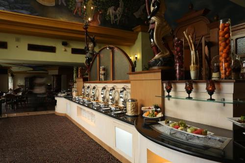 a restaurant with a counter with food on it at Aryaduta Suite Semanggi in Jakarta