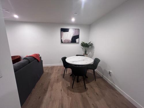 a living room with a table and a couch at Cozy home away from home in Calgary