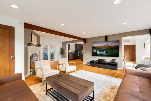 a living room with a couch and a table at Ultimate Group Getaway Near Ferry, Hot Tub and Games in Mukilteo
