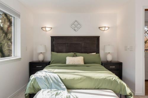 a bedroom with a green bed with two night stands at Ultimate Group Getaway Near Ferry, Hot Tub and Games in Mukilteo