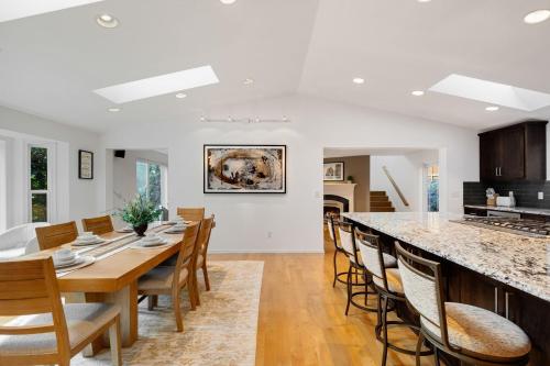 a kitchen and dining room with a table and chairs at Ultimate Group Getaway Near Ferry, Hot Tub and Games in Mukilteo