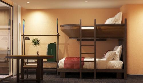 a room with two bunk beds and a table at Amiana Resort Cam Ranh in Cam Ranh