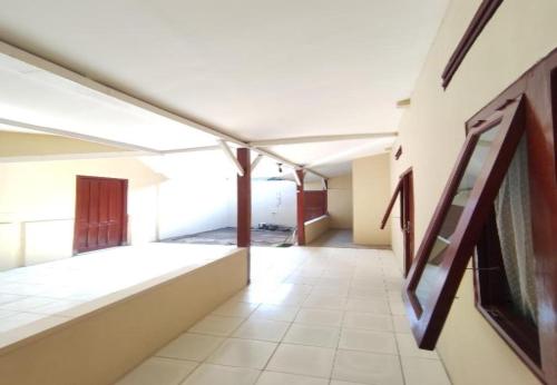 an empty hallway in a building with paintings on the wall at Khazanah Room Syariah by Secoms in Demangan