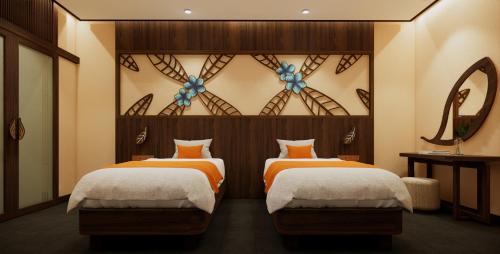a bedroom with two beds and a mirror at Amiana Resort Cam Ranh in Cam Ranh