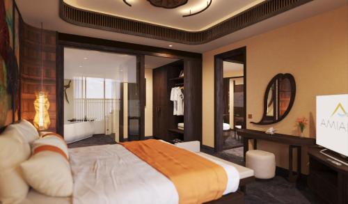 a bedroom with a large bed and a mirror at Amiana Resort Cam Ranh in Cam Ranh