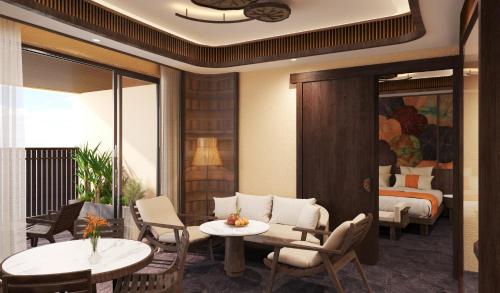 a room with two tables and chairs and a bed at Amiana Resort Cam Ranh in Cam Ranh